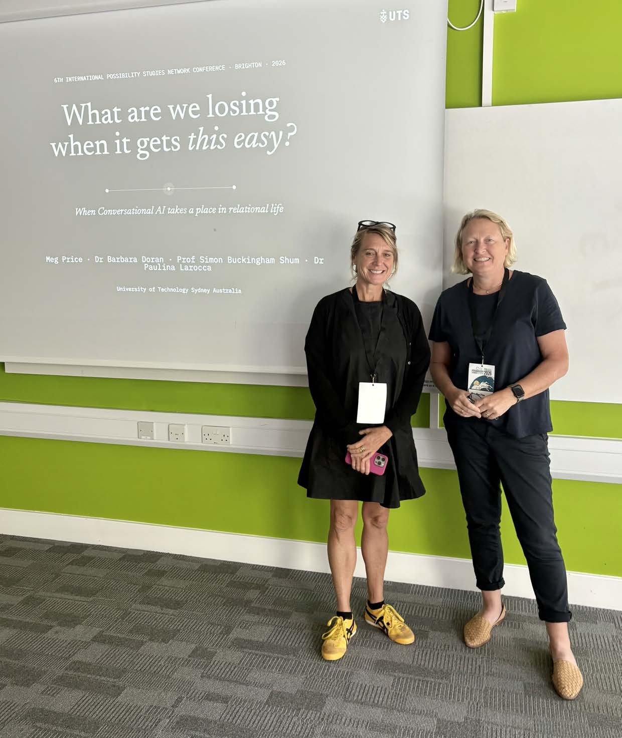 Meg Price and Dr Barbara Doran in front of the title slide at PSN 2026, Brighton